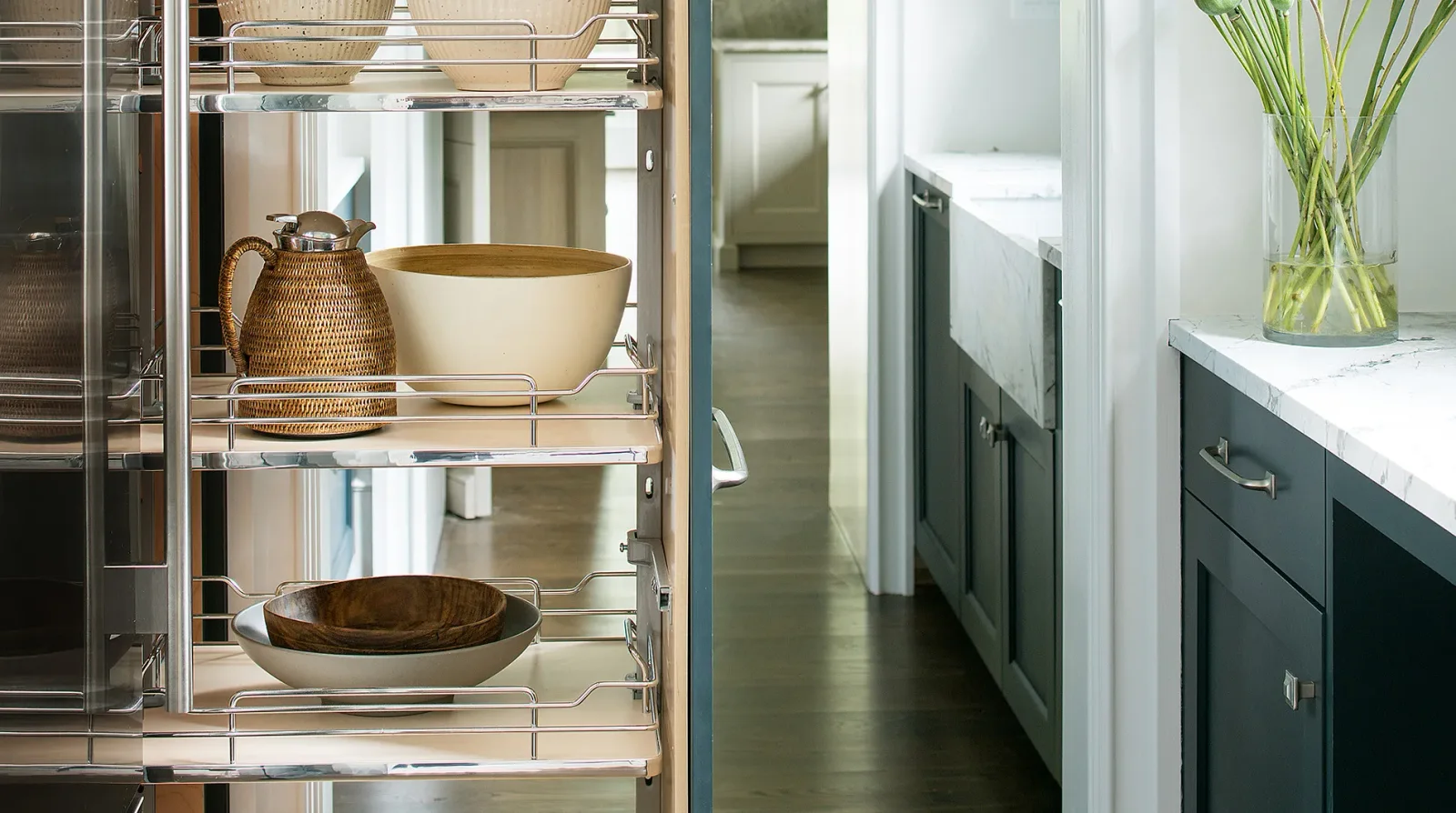 A tall pull-out pantry bringing stored cookware and serving pieces into view